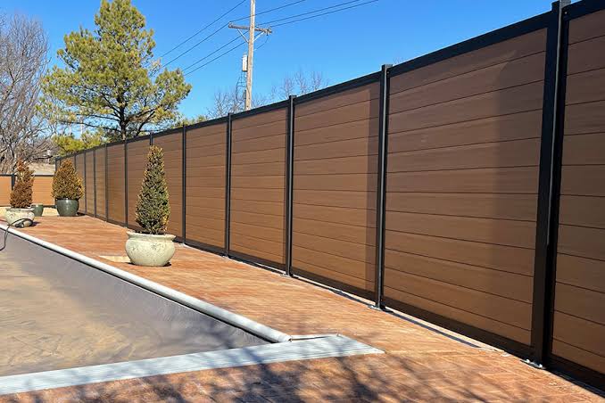 Vinyl privacy fence panels installed along a driveway in Lakeland, FL